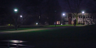 Dunkler Weg am Campus, nur wenige Lampen leuchten.